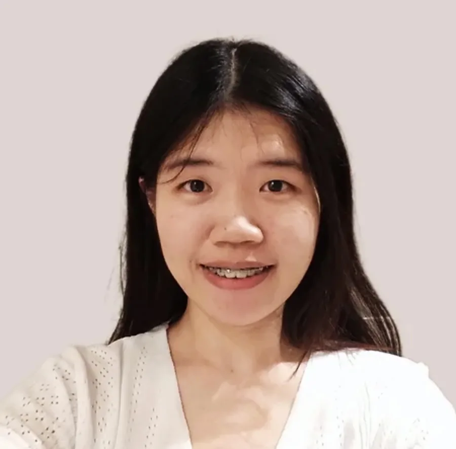 Smiling woman with long hair and braces.