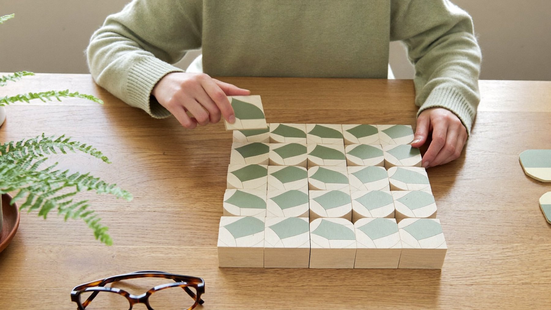 Wooden pattern blocks and shape tiles laid out on a table during a psychological assessment at BeLive in Psychology, Petaling Jaya