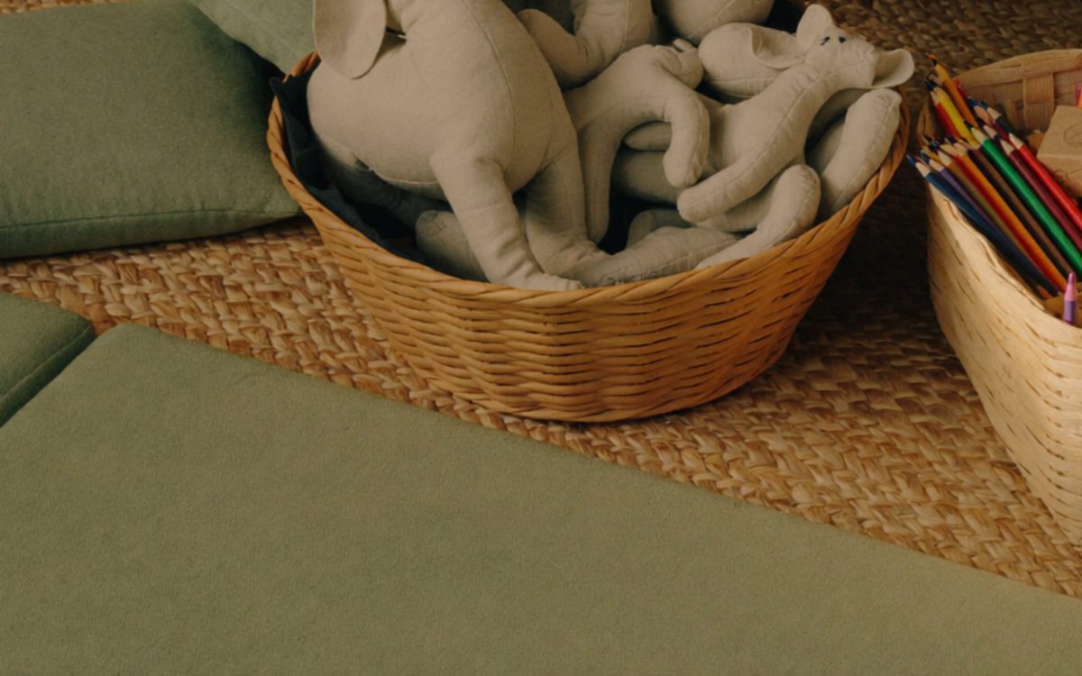 Child-friendly play therapy corner with soft toys, colouring pencils and floor cushions