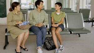A Malaysian family sitting together in a public hospital waiting area
