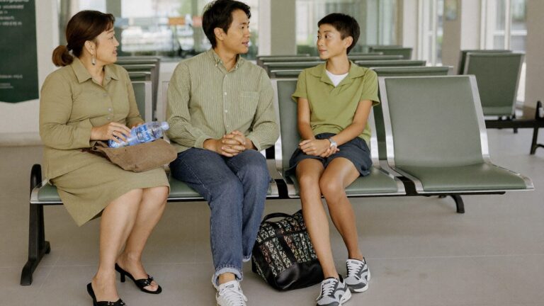 A Malaysian family sitting together in a public hospital waiting area