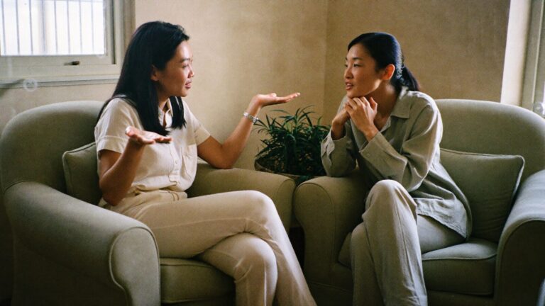 Two Malaysian mental health professionals talking in a warm consultation room